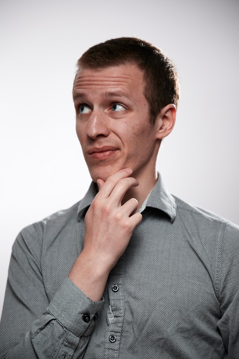 man in gray button up shirt thinking about term life insurance and its importance